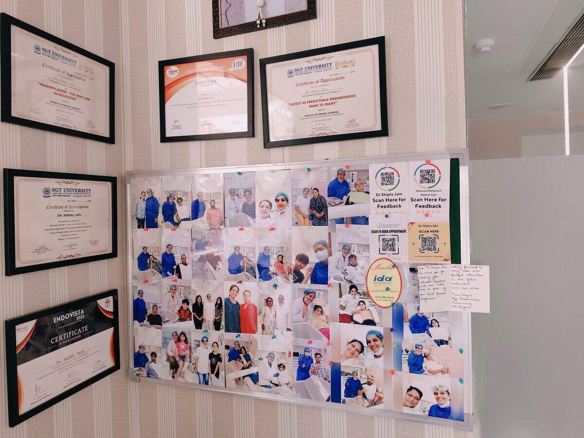 Qualifications and patient photographs on the wall at the clinic