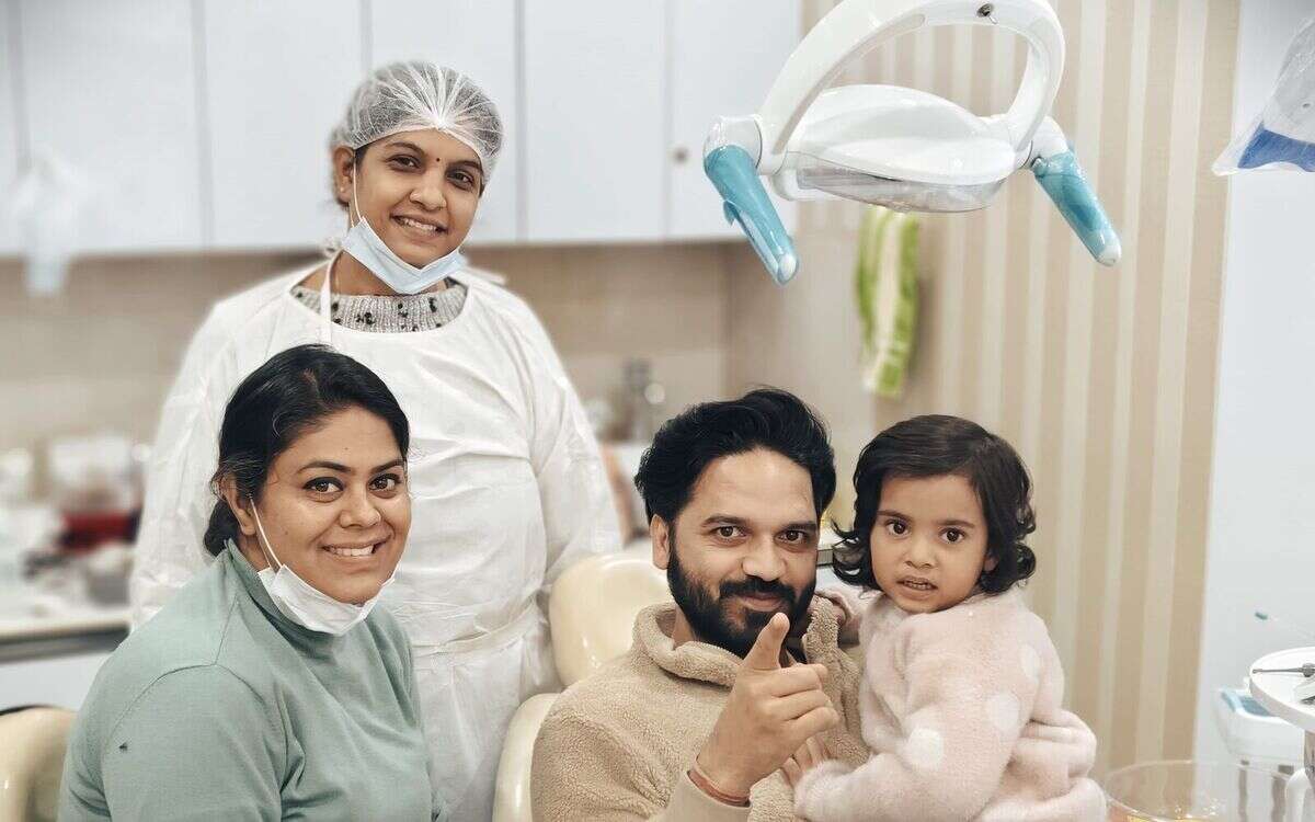 A family with their dentist after treatment at Mahavirai Dental