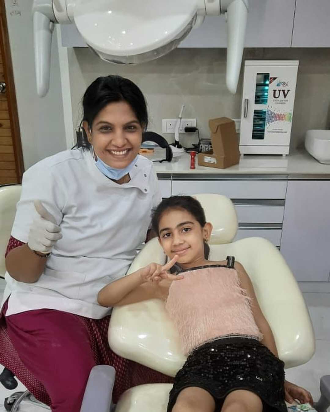 A happy child patient in the dental chair at the clinic